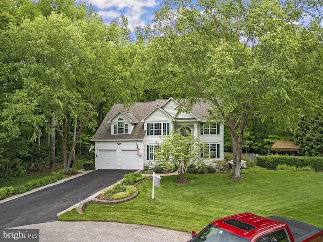 3211 Havenwood Ct, Edgewater, MD 21037 - view of front facade with driveway, an attached garage, a front lawn, and a shingled roof