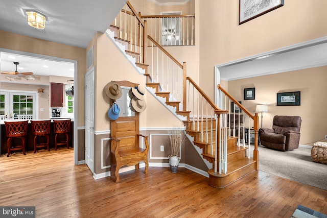 3211 Havenwood Ct, Edgewater, MD 21037 - stairs with ceiling fan, wood finished floors, a high ceiling, and crown molding
