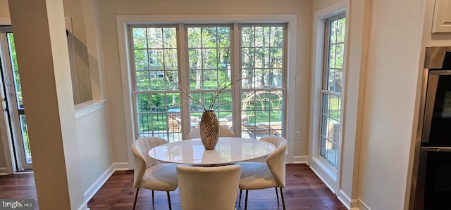 dining room with baseboards and dark wood-style flooring