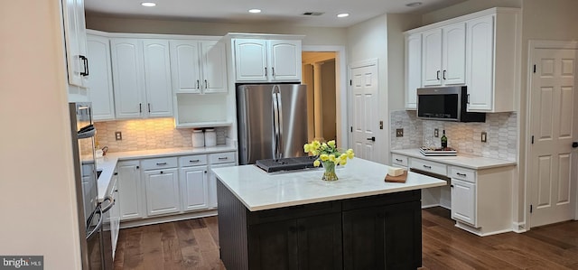 kitchen with white cabinets, stainless steel appliances, and dark wood-style flooring