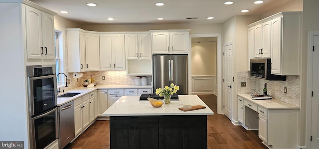 kitchen featuring decorative backsplash, appliances with stainless steel finishes, a sink, and recessed lighting