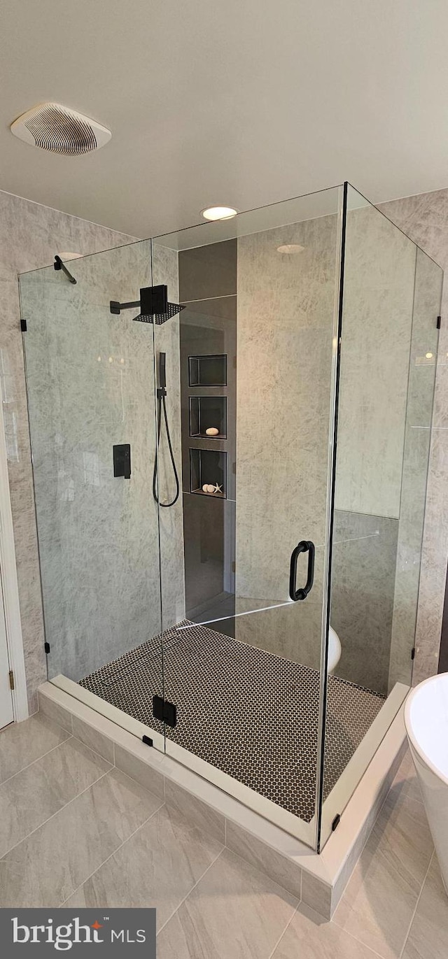 full bathroom with visible vents, marble finish floor, and a stall shower