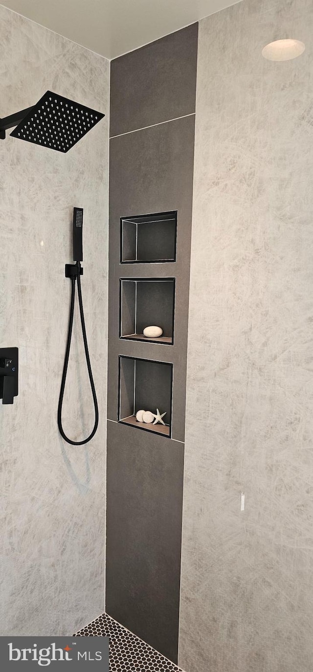 details featuring built in features and tiled shower