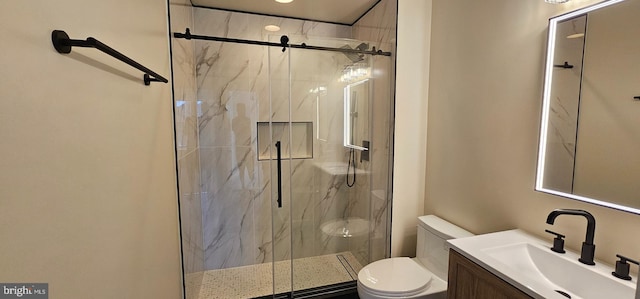bathroom with toilet, vanity, and a marble finish shower