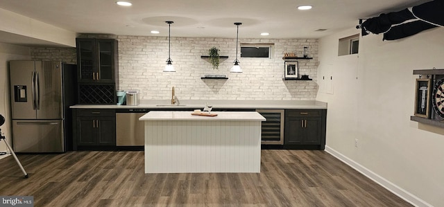 bar featuring dark wood finished floors, a sink, stainless steel appliances, and wine cooler