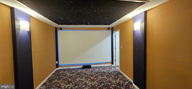 cinema room featuring carpet floors and baseboards