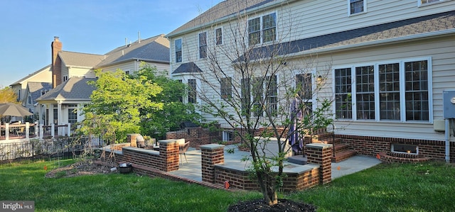 exterior space with a lawn, fence, and a patio area