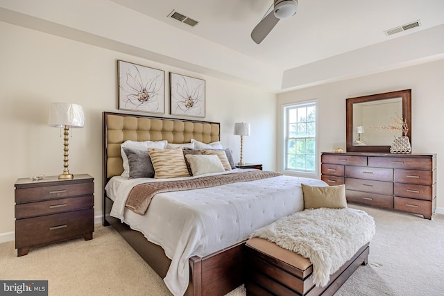 bedroom featuring visible vents, light carpet, and baseboards