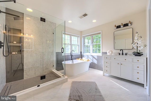 bathroom with recessed lighting, a shower stall, vanity, a freestanding tub, and visible vents