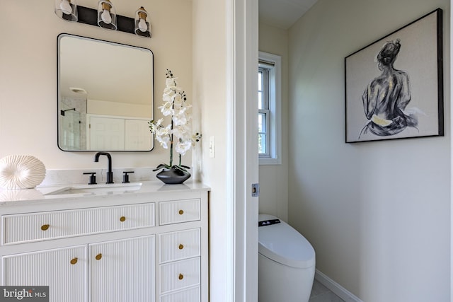 bathroom with toilet, tile patterned floors, vanity, and baseboards
