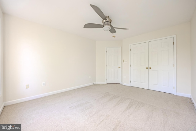 unfurnished bedroom with baseboards, a ceiling fan, a closet, and carpet flooring