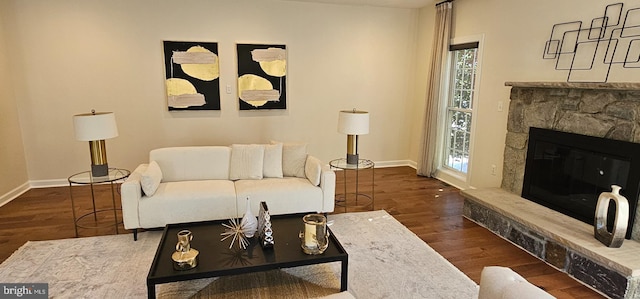 living area featuring baseboards, wood finished floors, and plenty of natural light