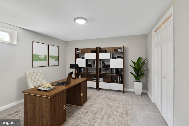 home office featuring baseboards and light carpet