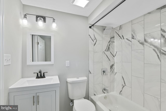 bathroom with vanity, bathtub / shower combination, and toilet
