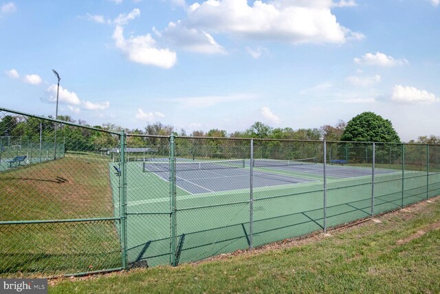 view of tennis court featuring fence