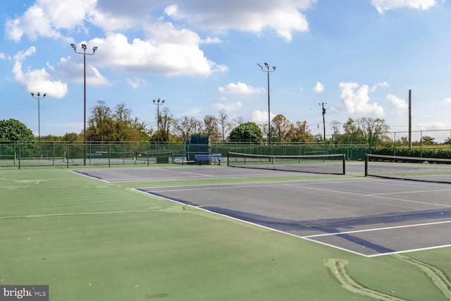 view of tennis court with fence