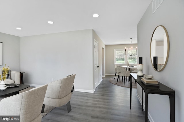 interior space featuring a chandelier, recessed lighting, baseboards, wood finished floors, and visible vents