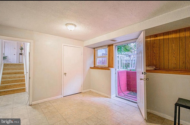 1207 Sunrise Ct, Herndon, VA 20170 - entrance foyer with a textured ceiling, stairway, baseboards, and light flooring