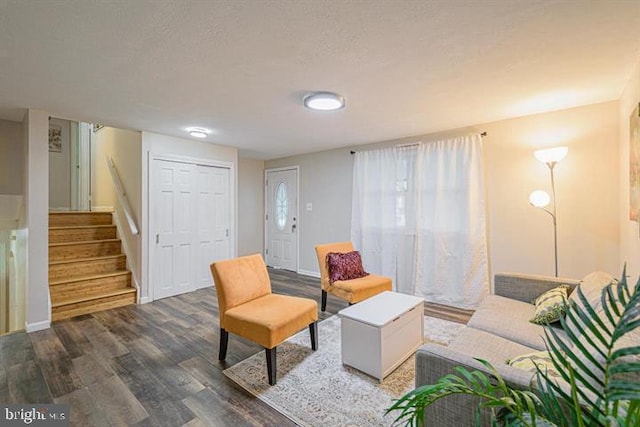 1207 Sunrise Ct, Herndon, VA 20170 - living area featuring wood finished floors, stairs, and a textured ceiling