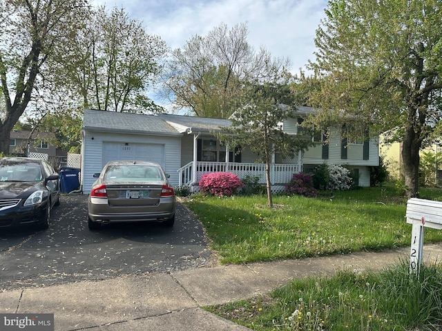 1207 Sunrise Ct, Herndon, VA 20170 - view of front of home with a garage, covered porch, asphalt driveway, and a front yard