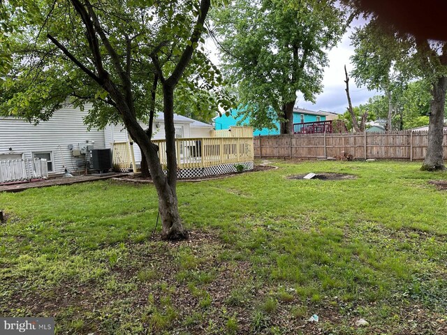 1207 Sunrise Ct, Herndon, VA 20170 - view of yard featuring a wooden deck and central air condition unit