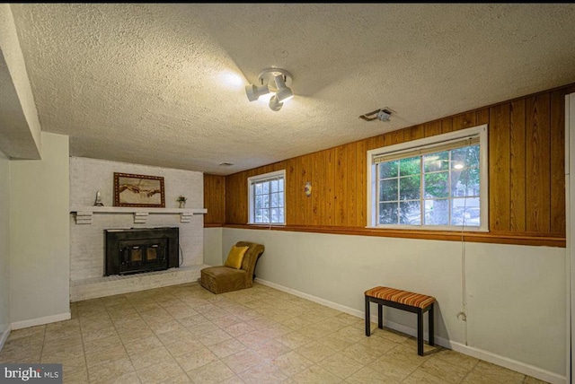 1207 Sunrise Ct, Herndon, VA 20170 - unfurnished room with a textured ceiling, a fireplace, baseboards, and wood walls