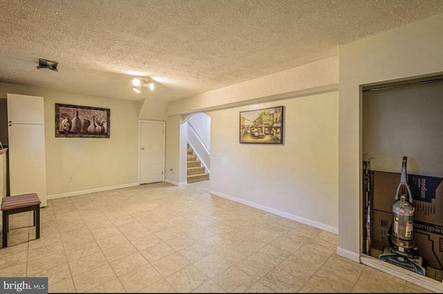 1207 Sunrise Ct, Herndon, VA 20170 - spare room featuring stairway, a textured ceiling, light floors, and baseboards