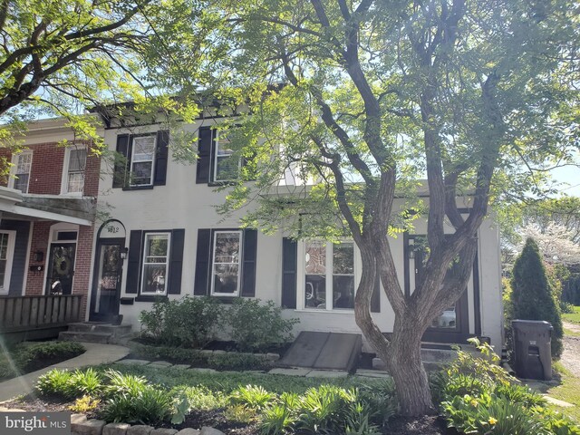 view of front facade featuring stucco siding and brick siding