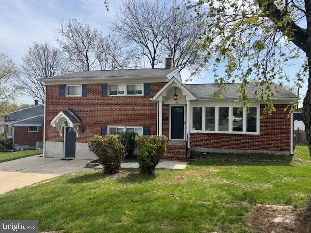 25 Haddington Rd, Lutherville Timonium, MD 21093 - tri-level home featuring brick siding, a chimney, and a front lawn