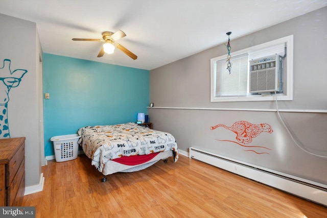 25 Haddington Rd, Lutherville Timonium, MD 21093 - bedroom featuring wood finished floors, baseboards, a wall mounted air conditioner, ceiling fan, and a baseboard radiator
