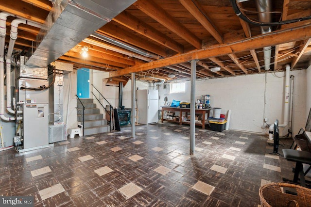 25 Haddington Rd, Lutherville Timonium, MD 21093 - basement with freestanding refrigerator, heating unit, tile patterned floors, and stairway