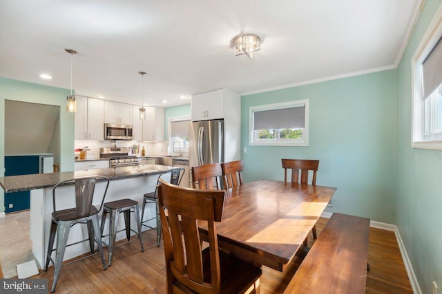 25 Haddington Rd, Lutherville Timonium, MD 21093 - dining space with baseboards, a healthy amount of sunlight, and light wood-type flooring