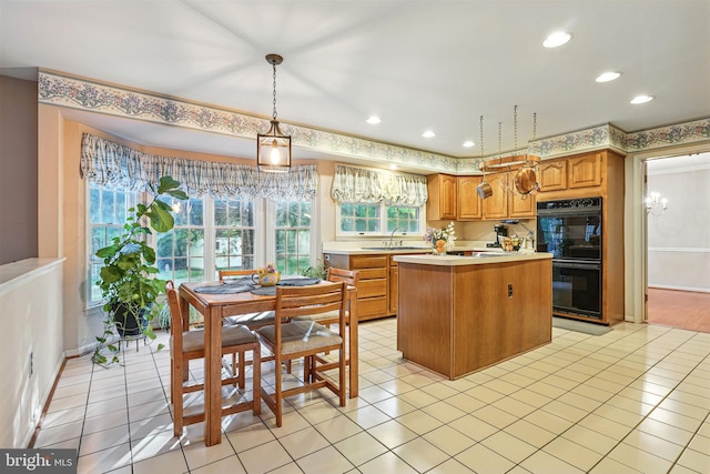 1728 Catherine Fran Dr, Accokeek, MD 20607 - kitchen with recessed lighting, a kitchen island, light countertops, dobule oven black, and a sink