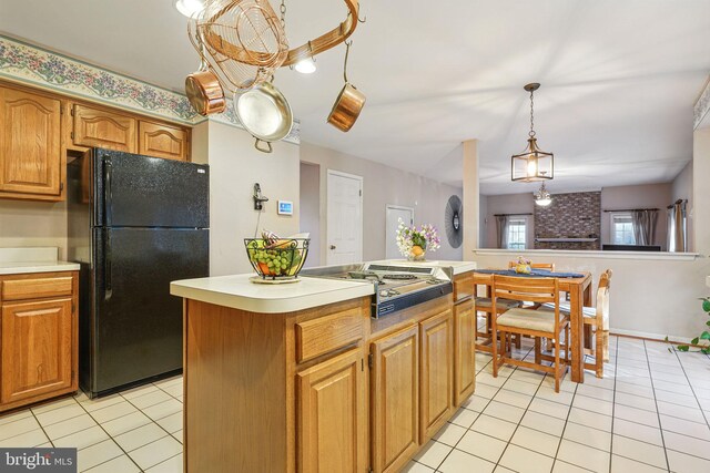 1728 Catherine Fran Dr, Accokeek, MD 20607 - kitchen featuring light tile patterned floors, light countertops, freestanding refrigerator, a center island, and stainless steel cooktop