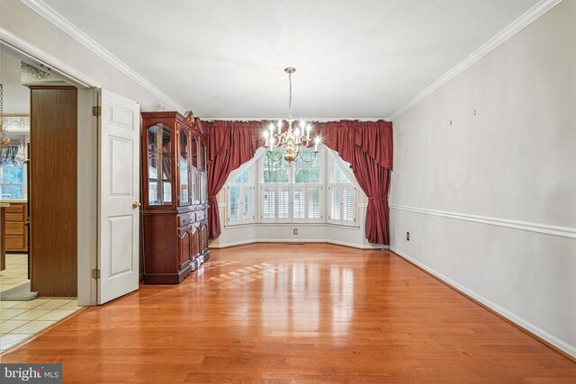1728 Catherine Fran Dr, Accokeek, MD 20607 - unfurnished dining area featuring wood finished floors, a chandelier, crown molding, and baseboards