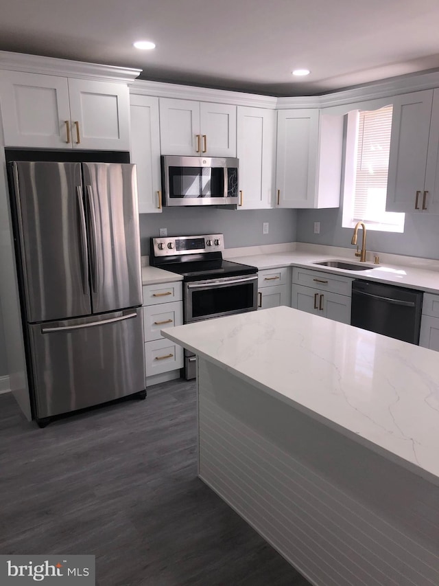 278 W Wellens Ave, Philadelphia, PA 19120 - kitchen featuring white cabinets, light stone counters, a sink, appliances with stainless steel finishes, and dark wood-style flooring