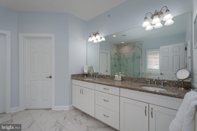 bathroom featuring a sink, a marble finish shower, marble finish floor, and a notable chandelier