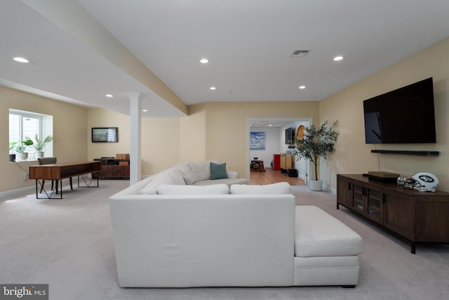 living area featuring visible vents, recessed lighting, decorative columns, and light carpet