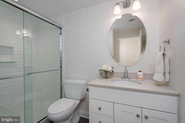 bathroom with visible vents, vanity, toilet, and tiled shower