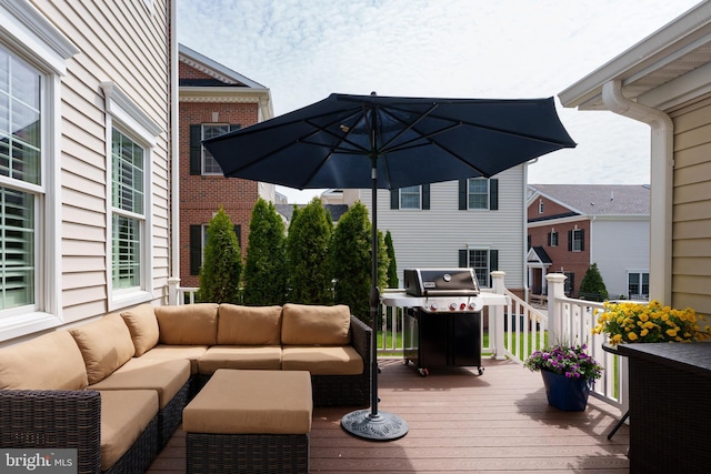 wooden terrace featuring area for grilling and an outdoor hangout area
