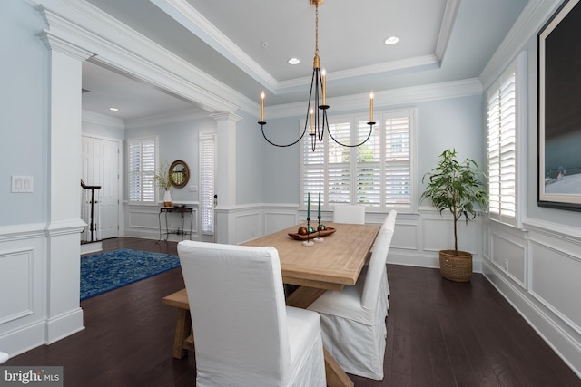 dining area featuring a decorative wall, a healthy amount of sunlight, and hardwood / wood-style floors