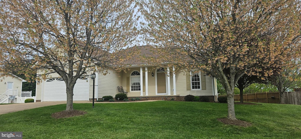 view of front of home featuring fence, a front lawn, and concrete driveway