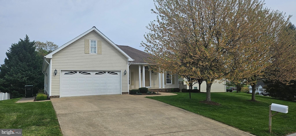 view of front of property with a garage, a front yard, and concrete driveway