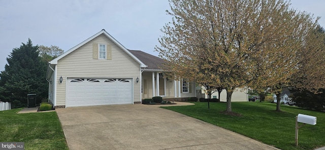 view of front of property with a garage, a front yard, and concrete driveway