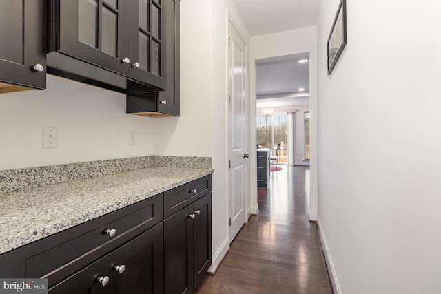 hallway with baseboards, dark wood-style flooring, and recessed lighting