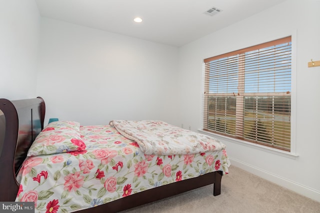 carpeted bedroom featuring baseboards, visible vents, and recessed lighting