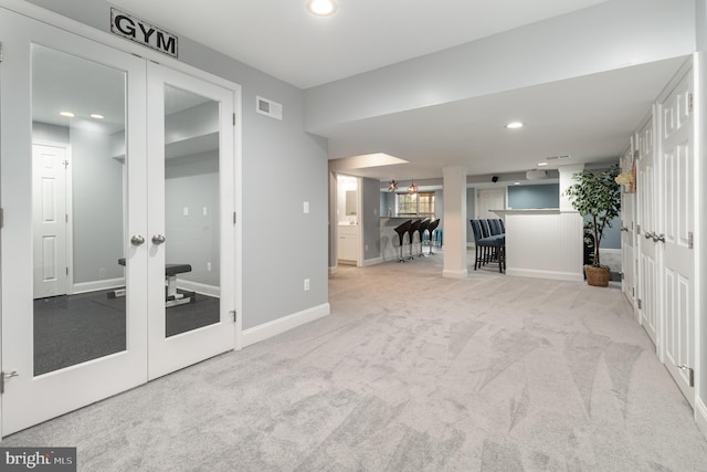 unfurnished living room with recessed lighting, visible vents, french doors, baseboards, and carpet flooring