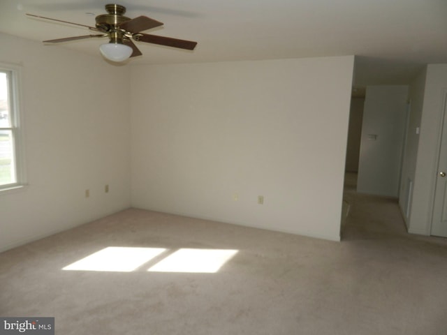 unfurnished room featuring a ceiling fan and light carpet
