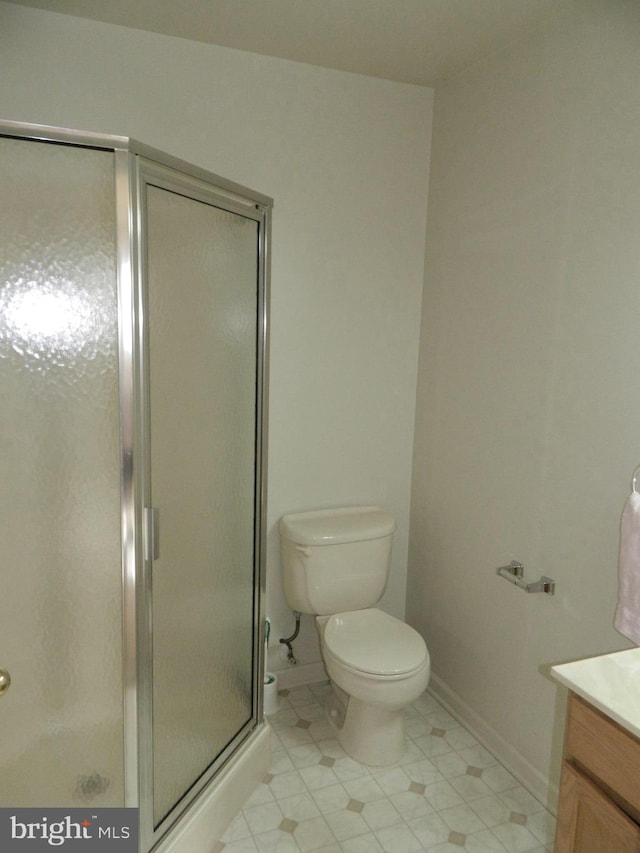 full bath featuring a shower stall, toilet, vanity, and tile patterned flooring