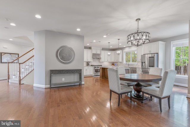 dining space featuring dark wood-type flooring, plenty of natural light, and baseboards